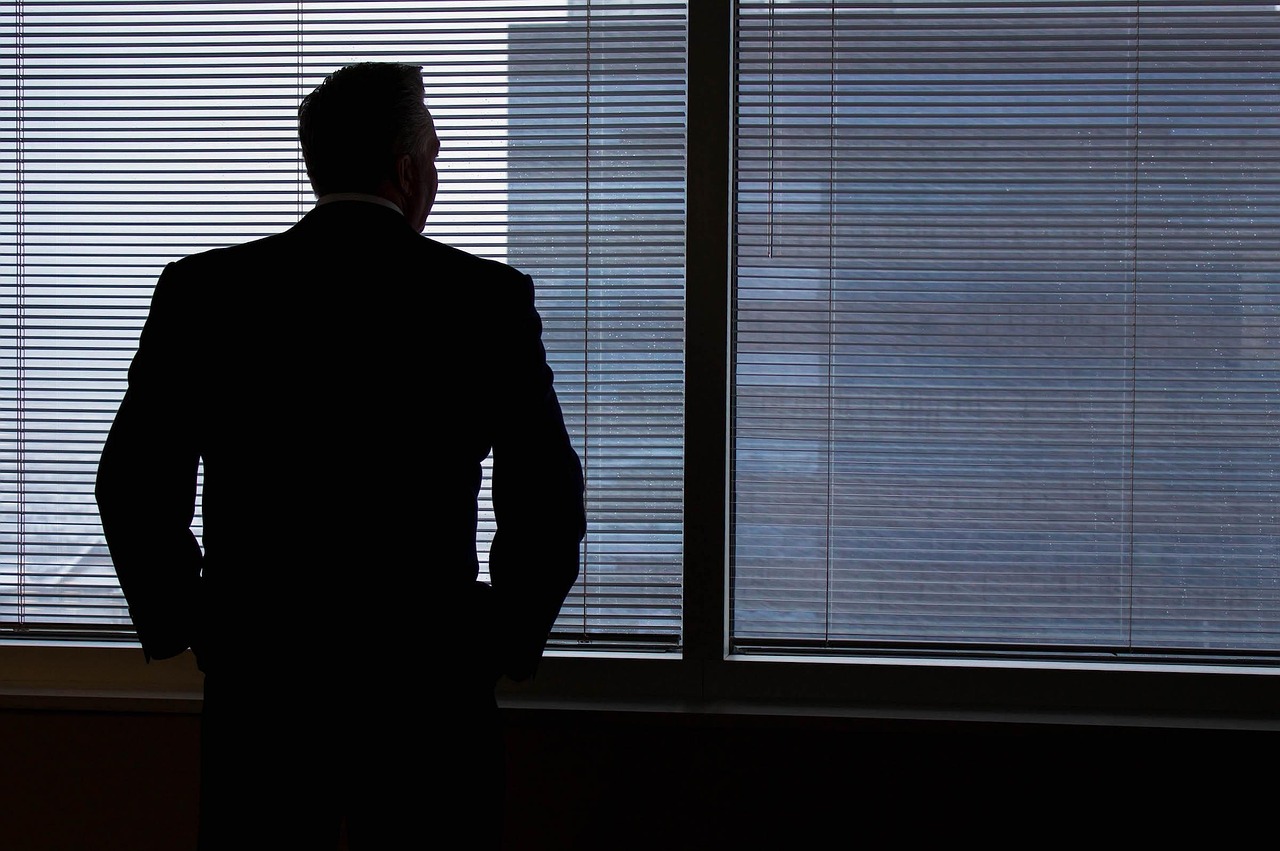 man acting as interim ceo behind a window